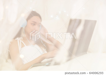 Woman work from home in bedroom Woman work from home in bedroom 64006293
