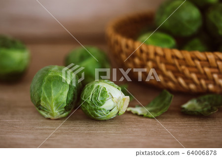 Fresh green brussel sprouts vegetable on a wooden Fresh green brussel sprouts vegetable on a wooden 64006878