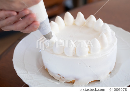 Making sweets at home decorating with cream 64006978