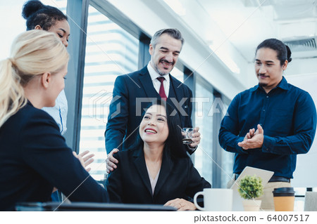 Business woman have praised by colleagues in team. Business woman have praised by colleagues in team. 64007517