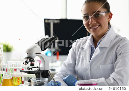 Cheerful chemist in uniform Cheerful chemist in uniform 64010160