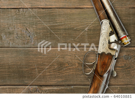Hunting rifle on a black background on dark brown Hunting rifle on a black background on dark brown 64010881