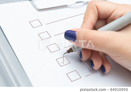 Hands writing check list and marker. Hands writing check list and marker. 64010950
