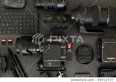 Top View of a Creative Filmmakers Office Desk with Lined up Camera and Gear Top View of a Creative Filmmakers Office Desk with Lined up Camera and Gear 64012555