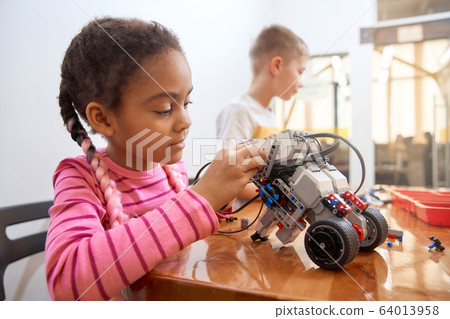 African girl creating robot. African girl creating robot. 64013958