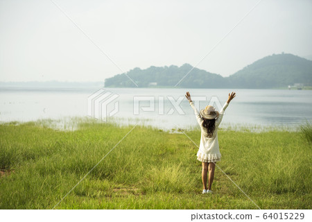 Back side woman feeling fresh freedom positive Back side woman feeling fresh freedom positive 64015229
