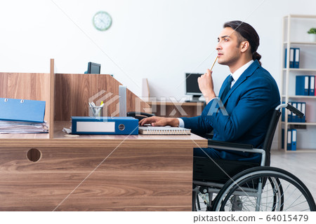 Young male employee in wheel-chair Young male employee in wheel-chair 64015479