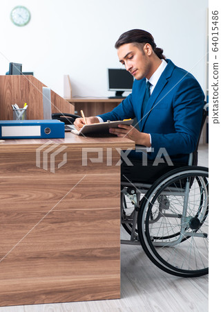 Young male employee in wheel-chair 64015486