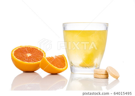 Series of orange flavored vitamin c effervescent tablet dropped and dissolve in glass of water Series of orange flavored vitamin c effervescent tablet dropped and dissolve in glass of water 64015495