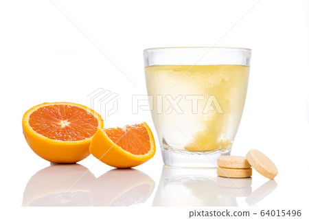 Series of orange flavored vitamin c effervescent tablet dropped and dissolve in glass of water Series of orange flavored vitamin c effervescent tablet dropped and dissolve in glass of water 64015496
