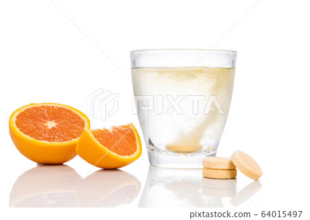 Series of orange flavored vitamin c effervescent tablet dropped and dissolve in glass of water Series of orange flavored vitamin c effervescent tablet dropped and dissolve in glass of water 64015497
