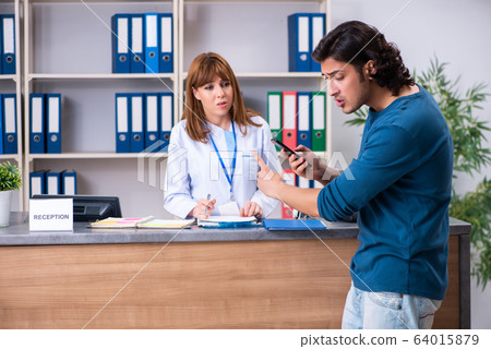 Young patient at the reception in the hospital Young patient at the reception in the hospital 64015879