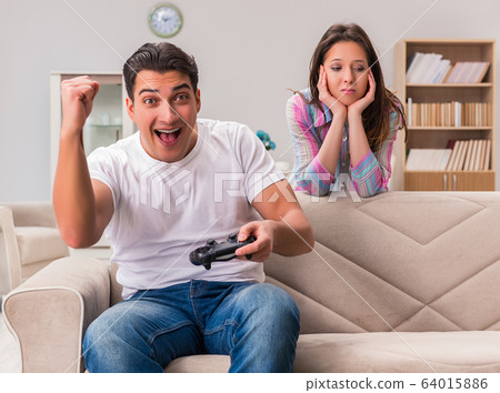 Young family suffering from computer games addiction 64015886