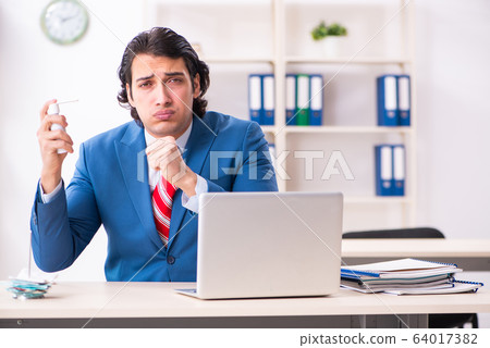 Young male employee suffering in the office 64017382