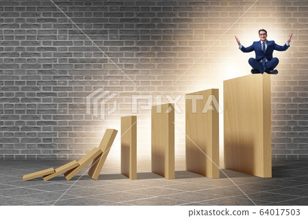 Businessman in domino effect concept 64017503