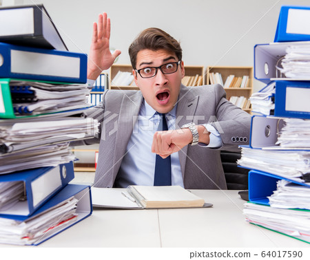 Busy businessman under stress due to excessive work 64017590
