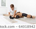 Carpenter worker installing laminate flooring in the room 64018942