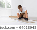 Craftsman installing laminate flooring in new apartment 64018943