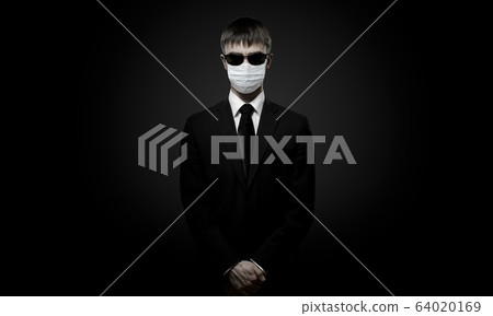 man in black costume in medical mask man in black costume in medical mask 64020169