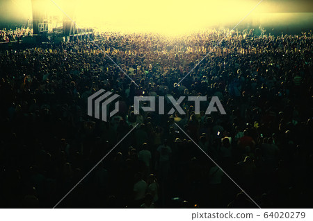 The bright light of the stage illuminates a huge 64020279