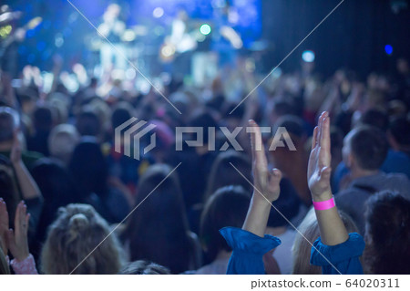 Audience applauded by the stage artist. Audience applauded by the stage artist. 64020311