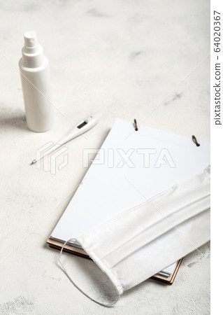 Nessesary items in daily life. Coronavirus prevention medical surgical mask, hand sanitizer gel for hand, digital thermometer and notebook on the white background. Nessesary items in daily life. Coronavirus prevention medical surgical mask, hand sanitizer gel for hand, digital thermometer and notebook on the white background. 64020367