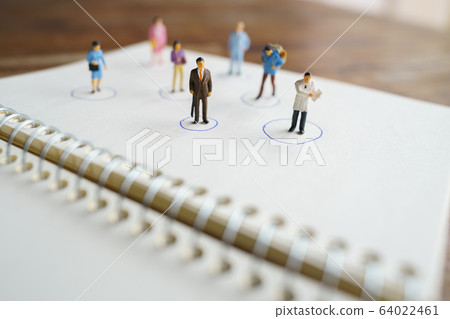 Social distancing. Miniature people stay apart to 64022461