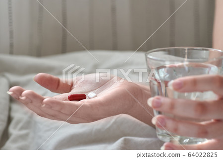 Close-up view of young woman's hands. Girl in bed Close-up view of young woman's hands. Girl in bed 64022825