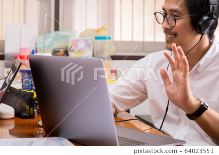 Businessman making video conference using laptop work from home. 64023551