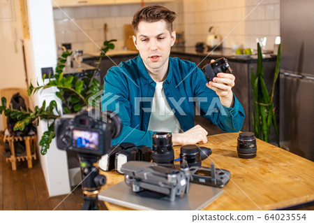 blogger photographer presenting different DSLR on camera 64023554