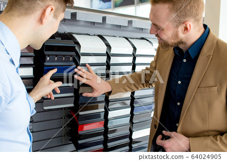 young customer and consultant look at colors palette young customer and consultant look at colors palette 64024905