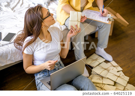 beautiful caucasian couple sorting letters at home 64025119