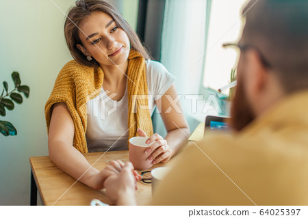 cute wife look at working husband with love 64025397