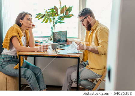attractive woman support and sit next to husband working at home 64025398
