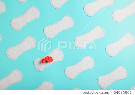 Many Sanitary pads on a blue background in the Many Sanitary pads on a blue background in the 64025901