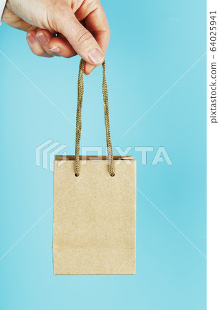 Small paper Bag at arm's length, brown craft bag 64025941