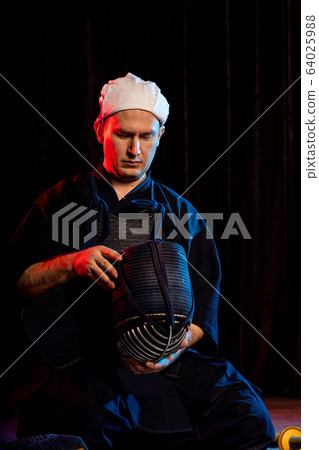 young caucasian male kendo fighter wear helmet on head young caucasian male kendo fighter wear helmet on head 64025988