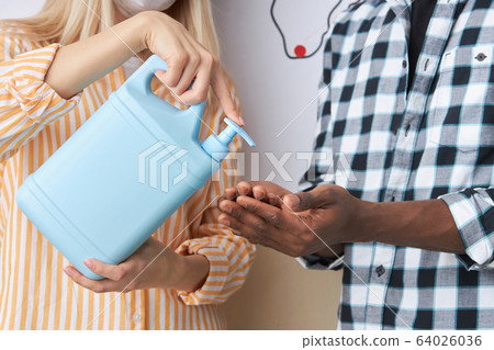 cropped people using spray for disinfection during coronavirus epidemic cropped people using spray for disinfection during coronavirus epidemic 64026036