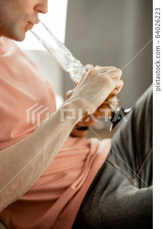 young man heats bong with a lighter young man heats bong with a lighter 64026223