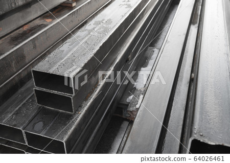 Stack of rolled metal products, gray steel pipes Stack of rolled metal products, gray steel pipes 64026461