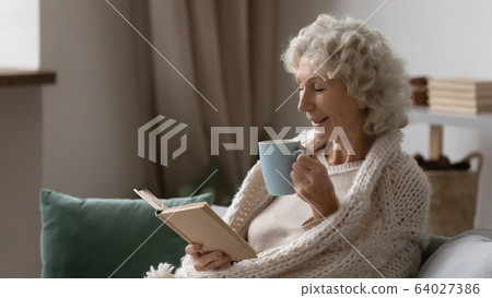Excited middle aged elderly granny enjoying weekend hobby time. Excited middle aged elderly granny enjoying weekend hobby time. 64027386