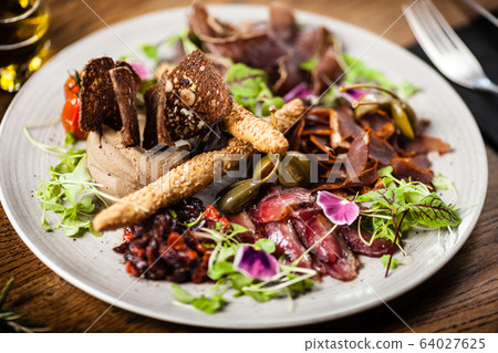 Meat platter for two served on a plate in restaurant 64027625