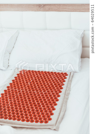 Acupuncture mat in the bed 64029511