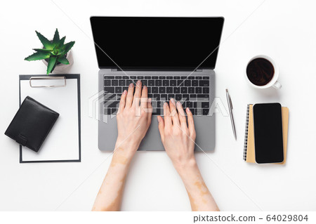 Closeup top view of woman working on laptop Closeup top view of woman working on laptop 64029804