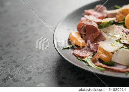 Salad with prosciutto, tangerines and vintage cheese with copy space 64029914