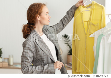 Millennial Girl Shopping Buying New Clothes In Store Millennial Girl Shopping Buying New Clothes In Store 64029974