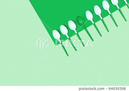 Photo with white spoons on blue background. 64030306