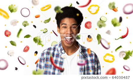 Collage with flying veggies and excited African American man on white background. Panorama 64030487