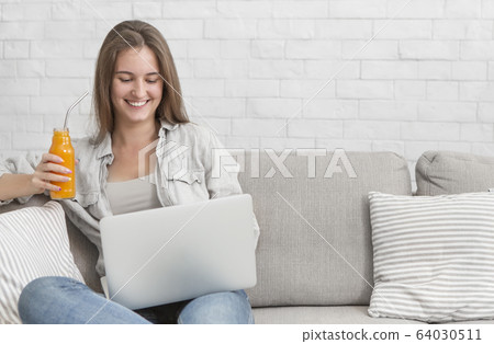 Young woman freelancer have good mood because drinking detox cocktails every day Young woman freelancer have good mood because drinking detox cocktails every day 64030511