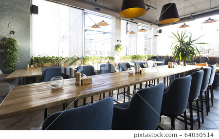 Cozy modern interior of restaurant with empty tables Cozy modern interior of restaurant with empty tables 64030514